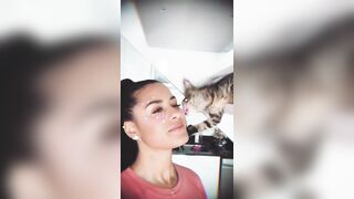 kat giving a kiss a cat