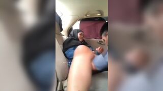 Muslim Hijab Woman in Backseat of Car