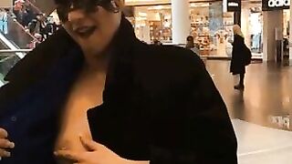 Woman rubs her tits at the mall