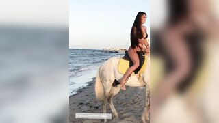 Helga Lovekaty: Posing with a horse in swimsuit