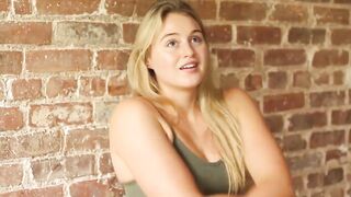 Stripping off her shirt during an interview - Iskra Lawrence