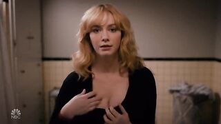 Celebrities: Christina Hendricks adjusting her consummate breasts