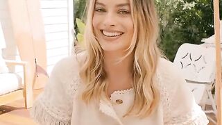 Celebrities: You can't aid but notice Margot Robbie eyeing you during the time that her husband blabbers on obliviously