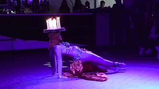 Balancing a tray of lit candles and abdomen dancing at the same time